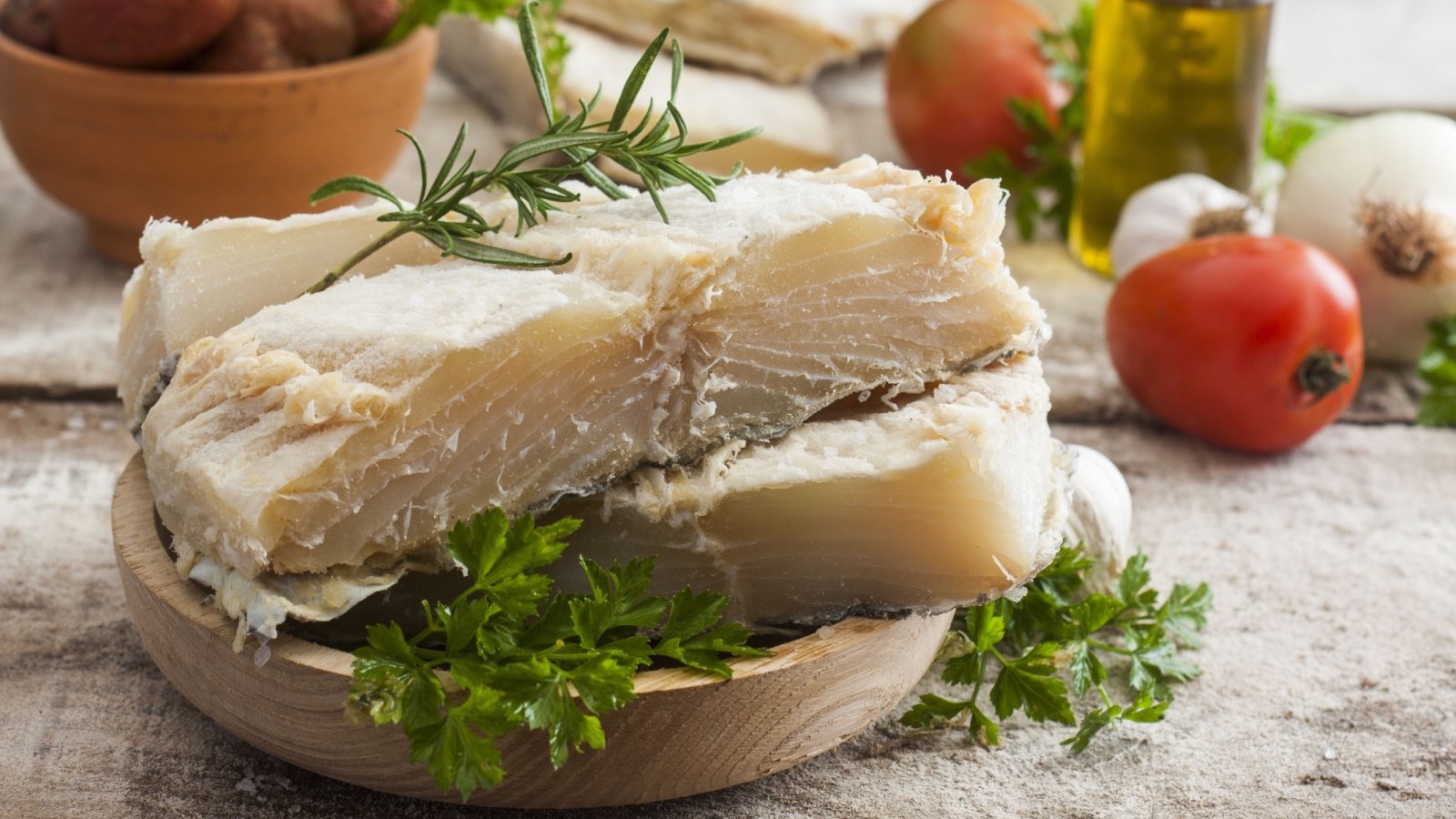 salted codfish food on the wooden table with ingredients Carlos andre Santos Shutterstock