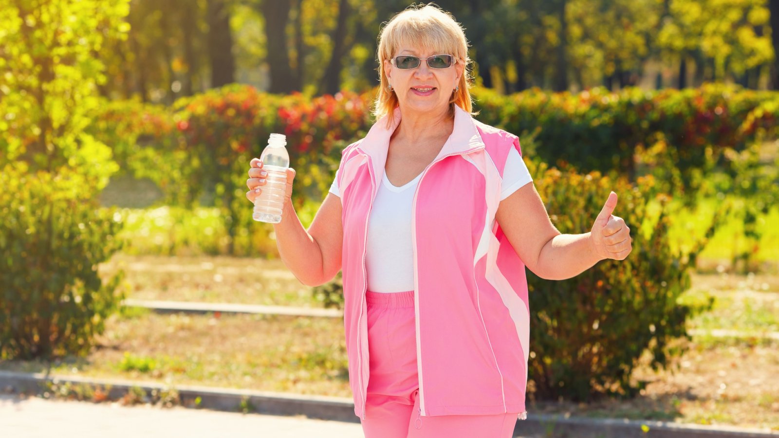 senior lady holding bottle of water workout a stock studio shutterstock