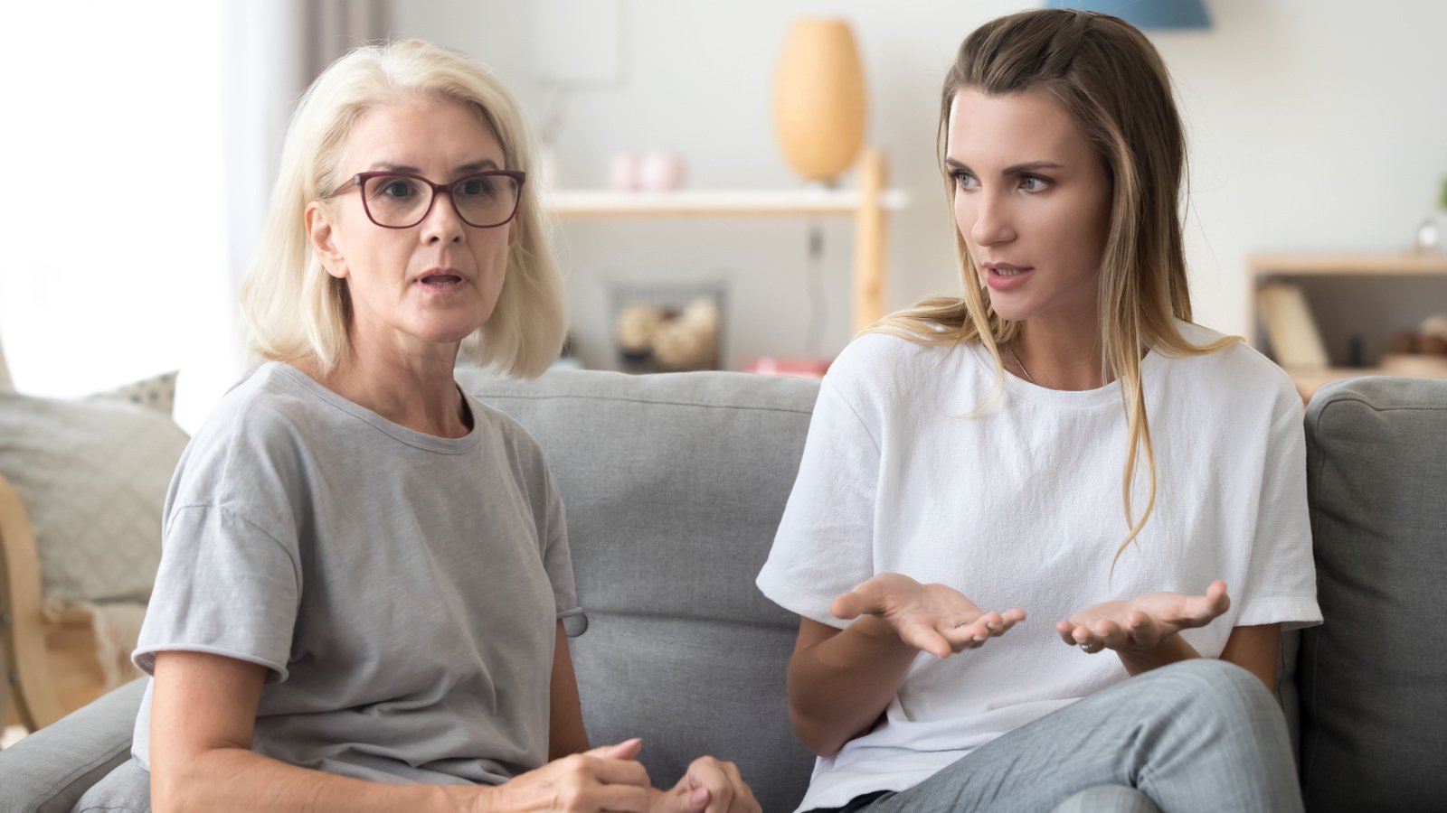 senior mother on couch in with young daughter girl teenager fighting fizkes shutterstock