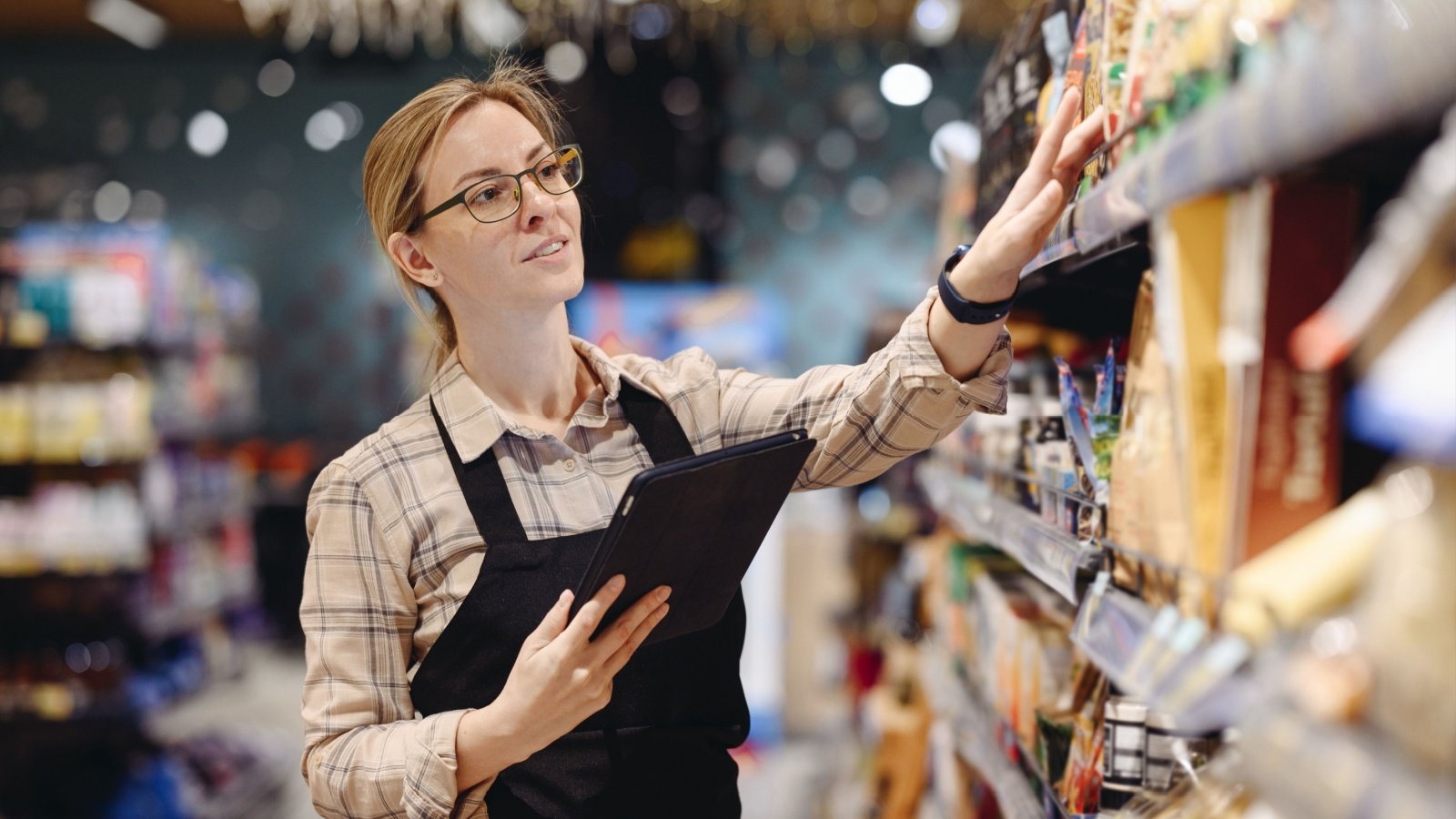 supermaket store grocery shop employee worker stock shelves ViDI Studio Shutterstock