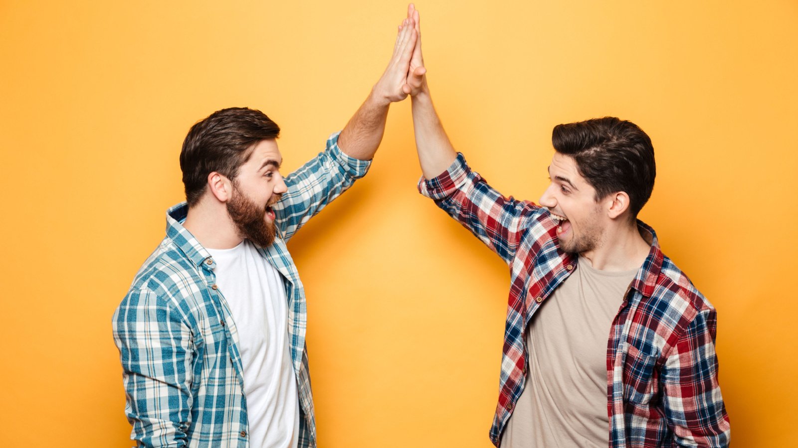 two happy young men giving high five shaking smile dean drobot shutterstock two happy young men giving high five shaking smile dean drobot shutterstock