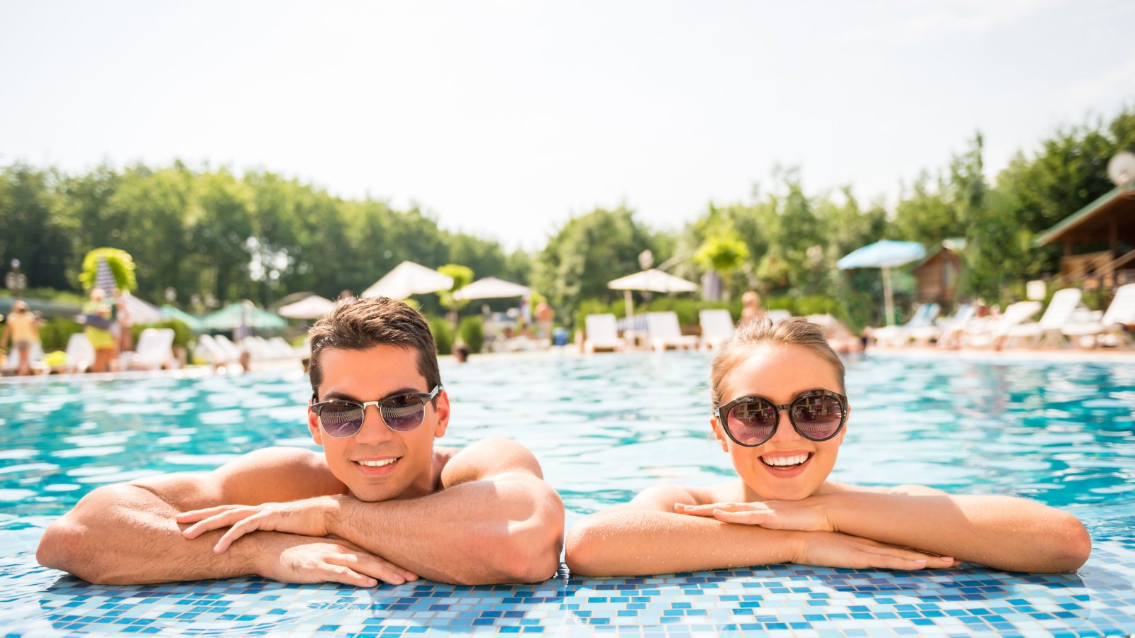 vacation relaxing in resort swimming pool vg stockstudio shutterstock