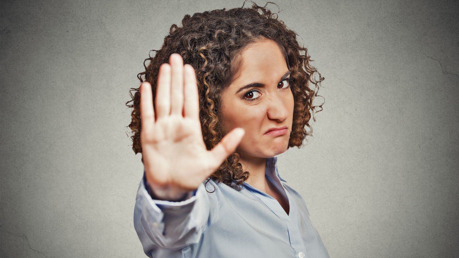 young annoyed angry woman with bad attitude giving talk to hand gesture with palm no stop pathdoc shutterstock