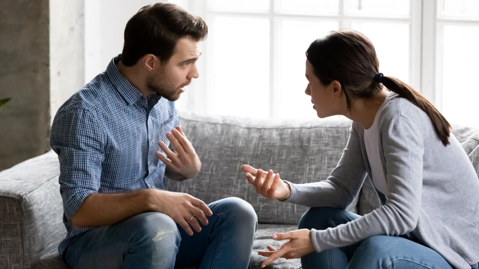 young couple talking fighting argument defensive fizkes shutterstock