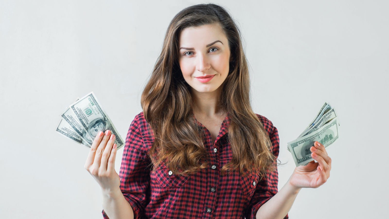 young girl holding dollar bills in hands money cash vakidzasi shutterstock