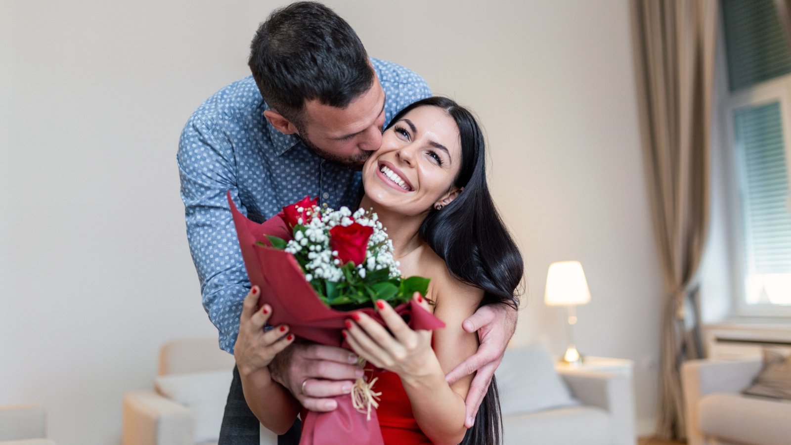 young happy couple kissing flowers roses engagement engaged together photoroyalty shutterstock