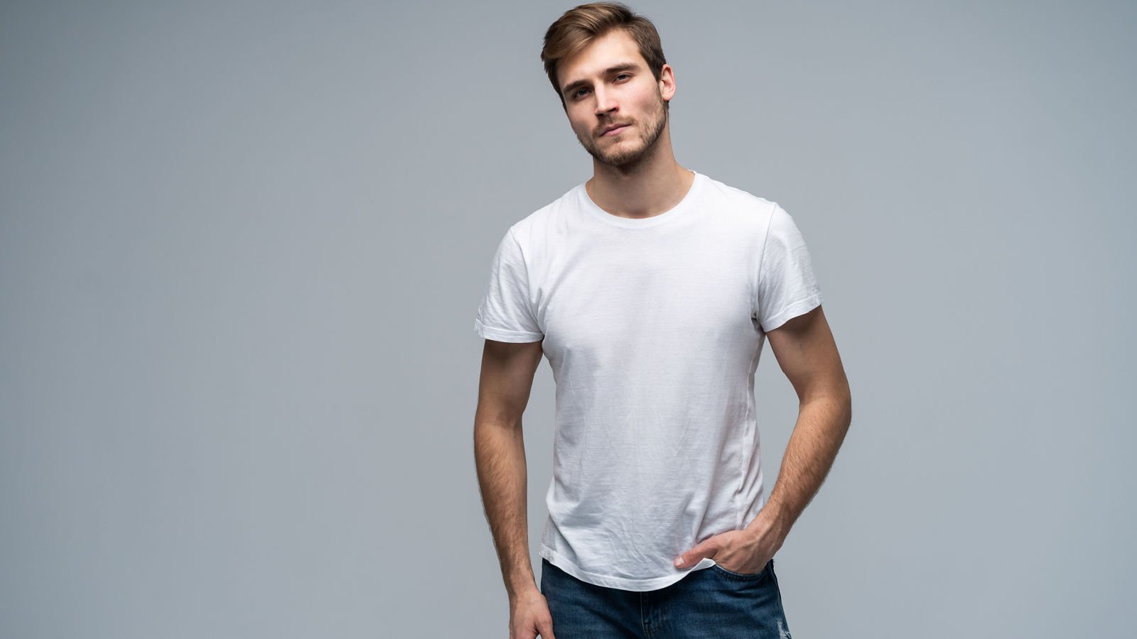 young male standing jeans opolja shutterstock