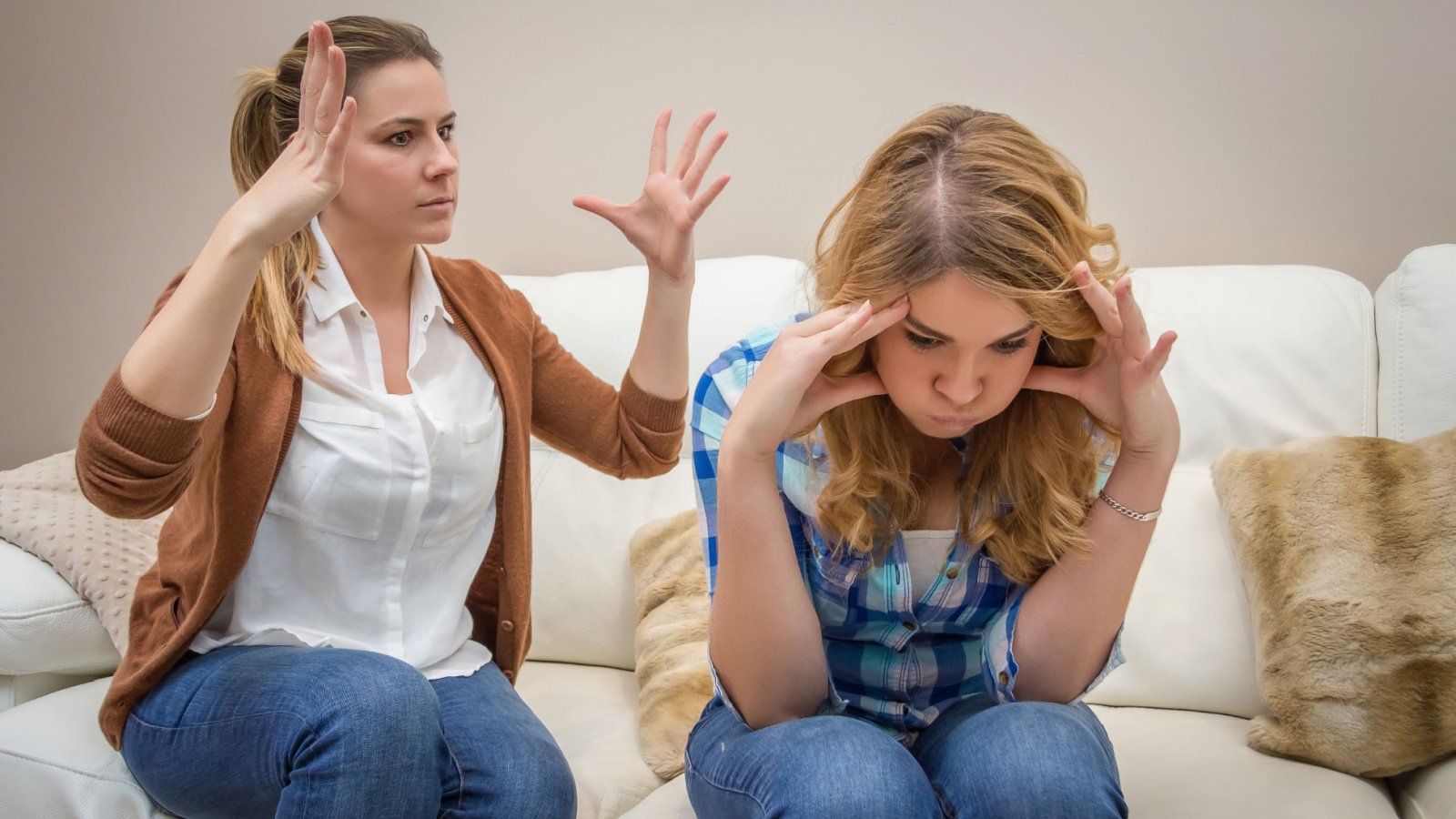 young mother in a discussion fight with her teenage daughter david pereiras shutterstock