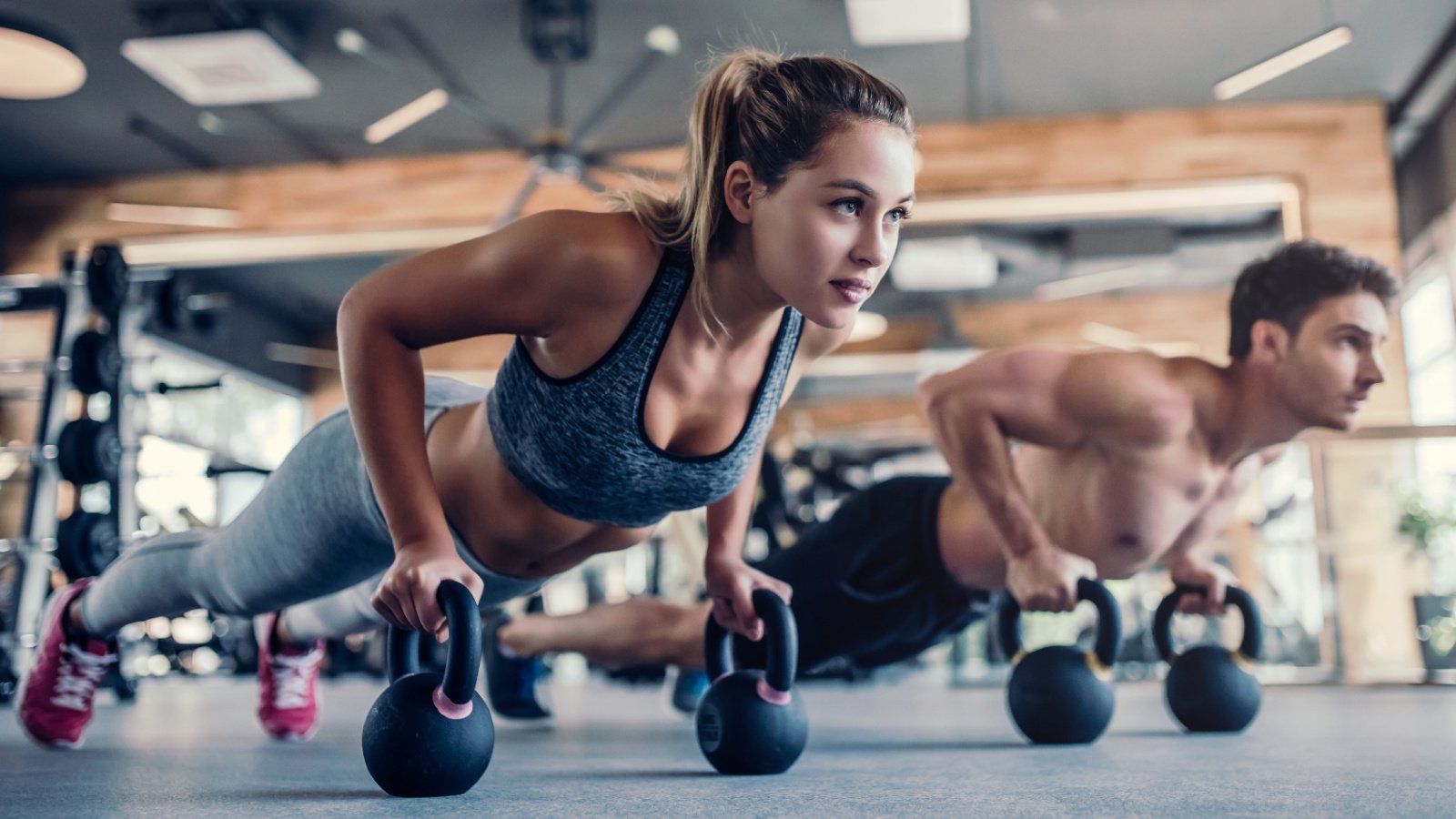 young woman couple working out fitness gym weight health