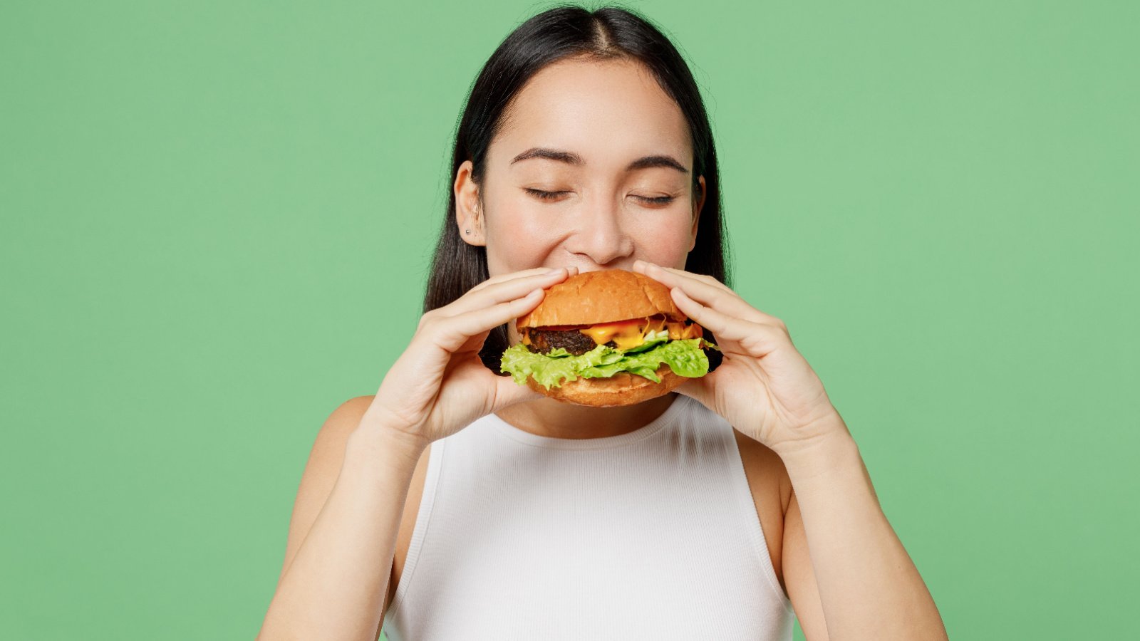 young woman eating a hamburger