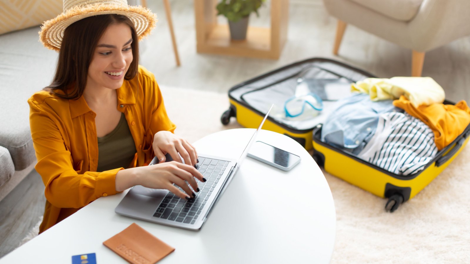 young woman planning vacation travel with laptop Prostock studio Shutterstock