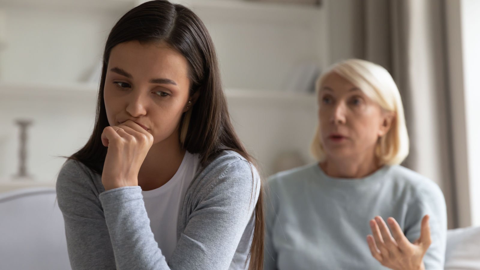 young woman sitting with elderly mother she scolding fizkes shutterstock