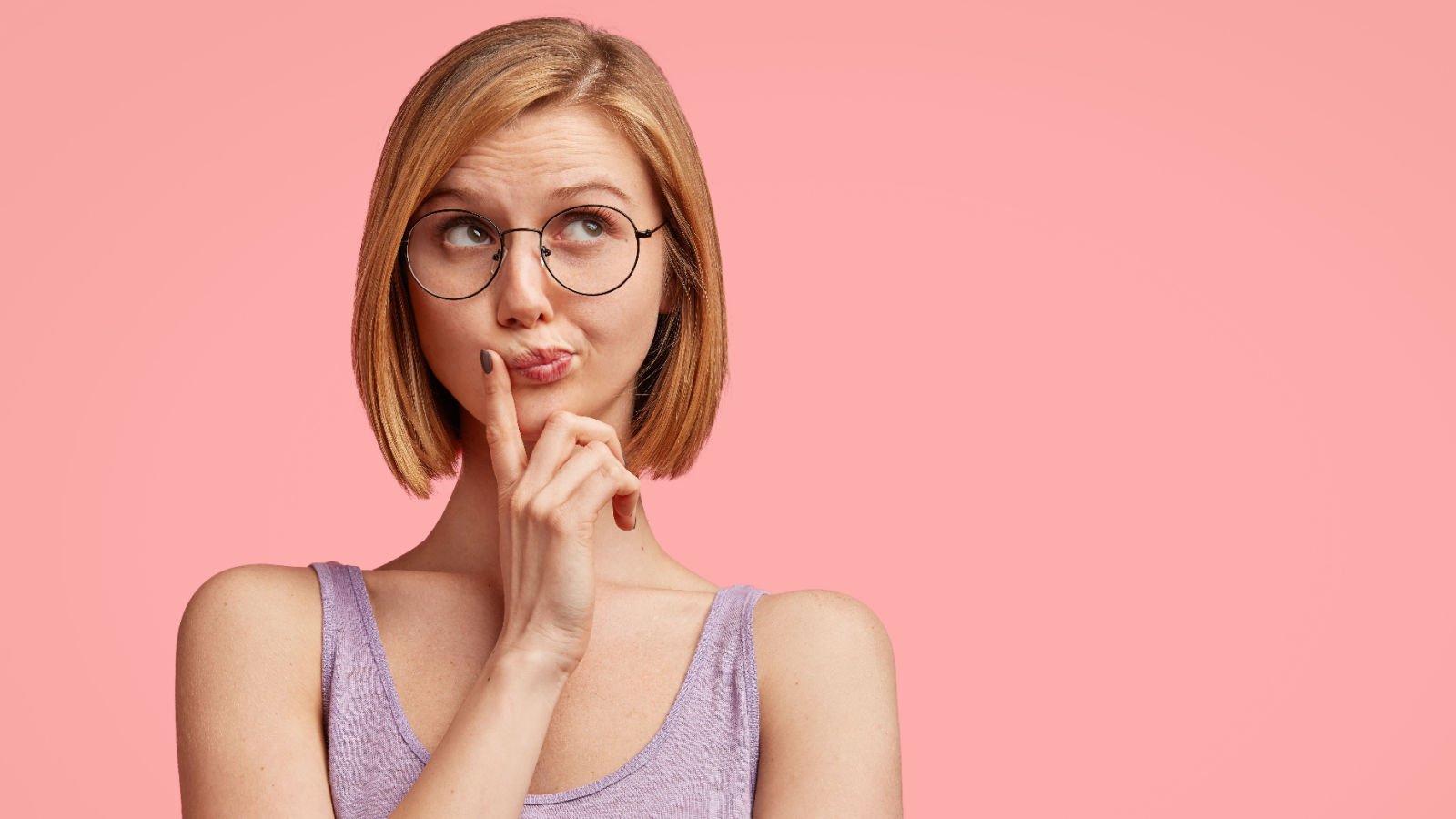 young woman student looks pensively upwards thinking cast of thousands shutterstock